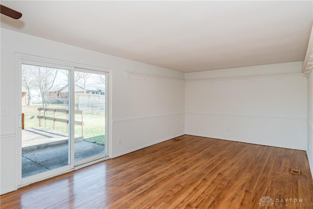 empty room with light wood-style floors and ceiling fan