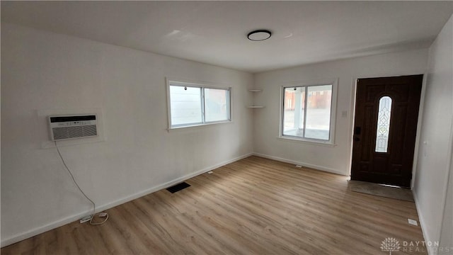 229 First, Piqua, OH 45356 - foyer with wood finished floors, baseboards, and a wall unit AC