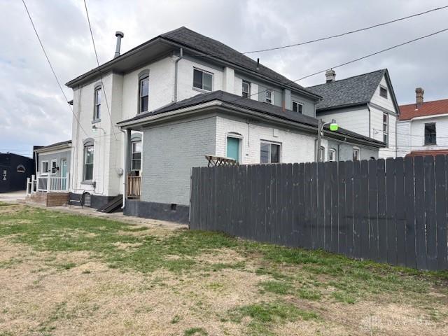 324 Warren St, Dayton, OH 45402 - view of side of property featuring fence and brick siding