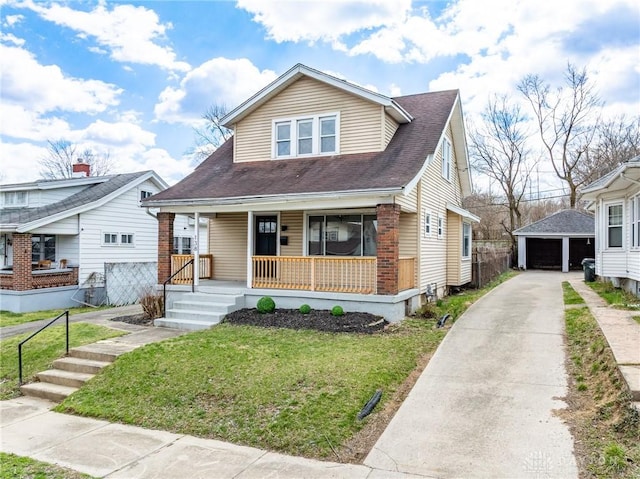bungalow featuring an outbuilding, fence, a detached garage, a front yard, and a porch