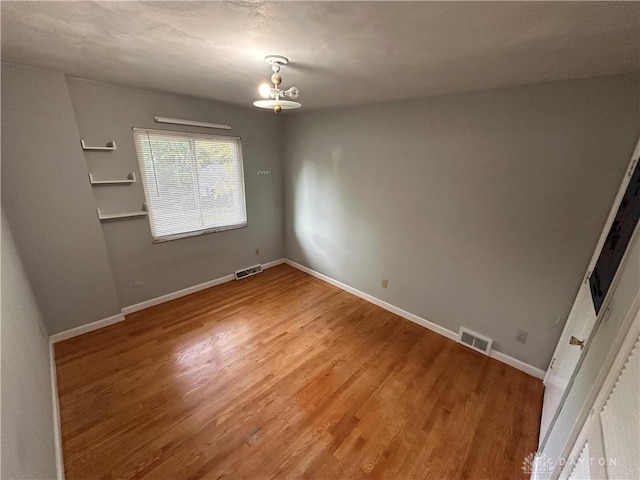 1314 Ridgeview Ave, Dayton, OH 45409 - spare room with wood finished floors and a chandelier