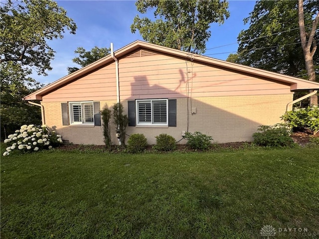 1314 Ridgeview Ave, Dayton, OH 45409 - view of home's exterior with brick siding and a lawn