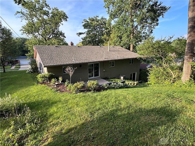 1314 Ridgeview Ave, Dayton, OH 45409 - back of house featuring a lawn, a chimney, roof with shingles, and a patio