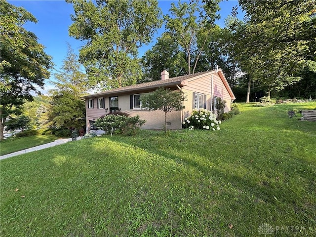 1314 Ridgeview Ave, Dayton, OH 45409 - ranch-style home featuring a chimney, brick siding, and a front lawn