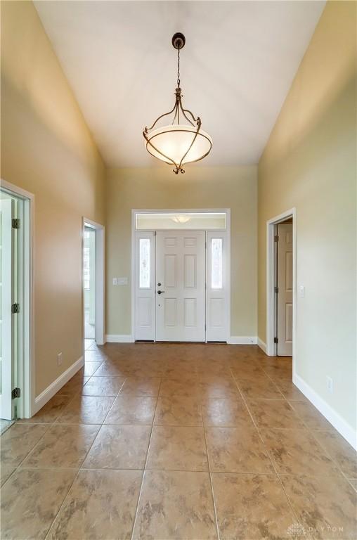 1713 Country Corner Ln, Washington Twp, OH 45458 - foyer featuring high vaulted ceiling, light tile patterned flooring, and baseboards
