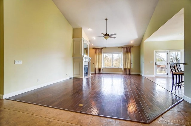1713 Country Corner Ln, Washington Twp, OH 45458 - unfurnished living room featuring lofted ceiling, ceiling fan, a fireplace, wood finished floors, and baseboards