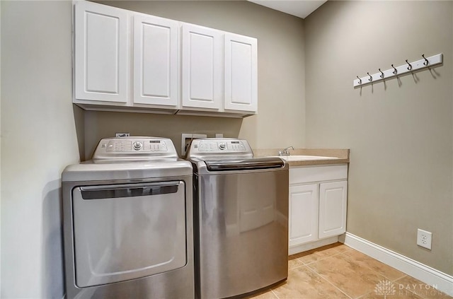 1713 Country Corner Ln, Washington Twp, OH 45458 - laundry area featuring cabinet space, separate washer and dryer, baseboards, and light tile patterned flooring