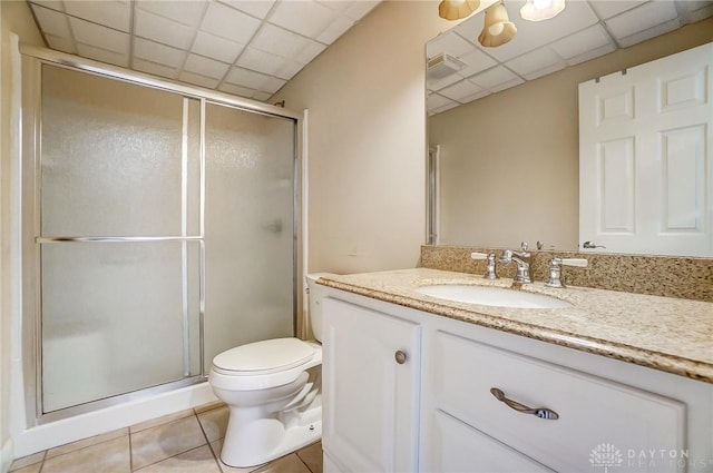 1713 Country Corner Ln, Washington Twp, OH 45458 - bathroom featuring toilet, vanity, a paneled ceiling, tile patterned flooring, and a stall shower