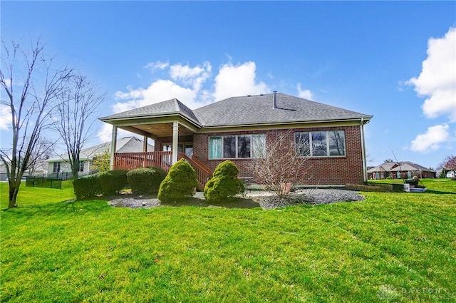 1713 Country Corner Ln, Washington Twp, OH 45458 - rear view of property featuring a yard, brick siding, covered porch, and roof with shingles