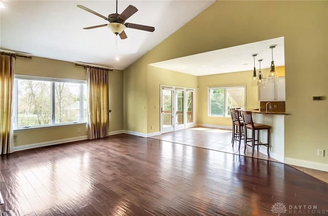 1713 Country Corner Ln, Washington Twp, OH 45458 - unfurnished living room with dark wood-type flooring, a ceiling fan, baseboards, high vaulted ceiling, and recessed lighting