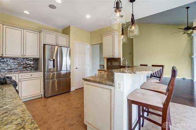 1713 Country Corner Ln, Washington Twp, OH 45458 - kitchen with stainless steel fridge with ice dispenser, tasteful backsplash, ceiling fan, a kitchen breakfast bar, and a peninsula