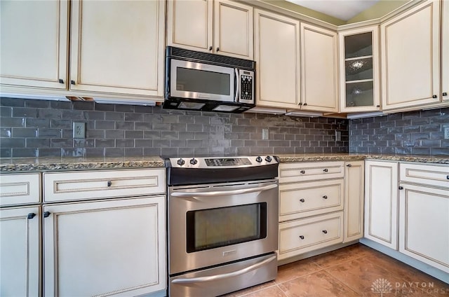 1713 Country Corner Ln, Washington Twp, OH 45458 - kitchen featuring stainless steel appliances, cream cabinets, tasteful backsplash, stone counters, and light tile patterned floors