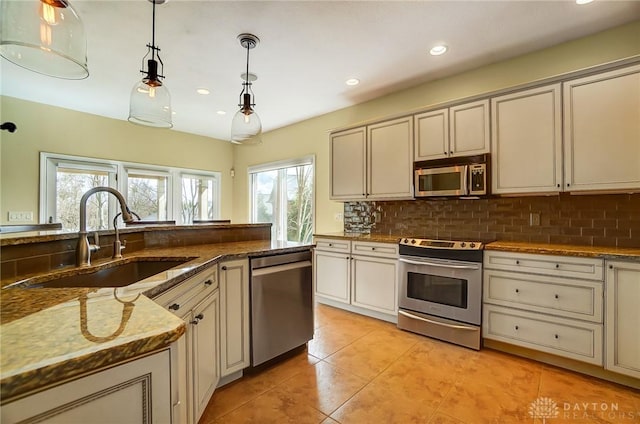 1713 Country Corner Ln, Washington Twp, OH 45458 - kitchen with stainless steel appliances, a sink, light tile patterned floors, backsplash, and recessed lighting