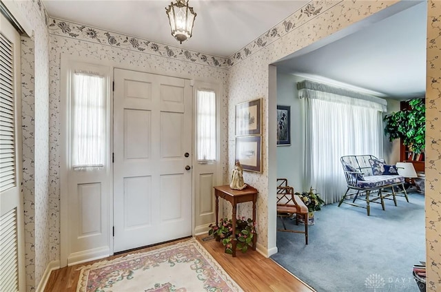 127 W Woodbury Dr, Dayton, OH 45415 - foyer featuring wallpapered walls, wood finished floors, and baseboards