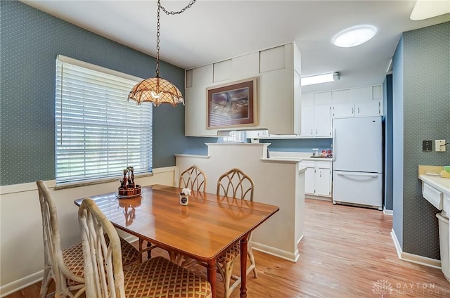 127 W Woodbury Dr, Dayton, OH 45415 - dining room with wallpapered walls and light wood-style floors