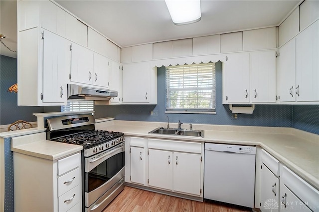127 W Woodbury Dr, Dayton, OH 45415 - kitchen featuring a sink, white dishwasher, light countertops, under cabinet range hood, and stainless steel gas stove