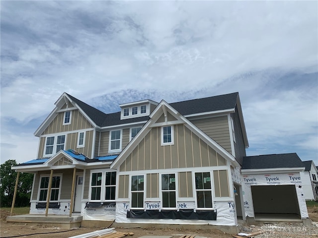 6900 Welney Run, Liberty Twp, OH 45044 - view of front of house with board and batten siding, an attached garage, and a shingled roof