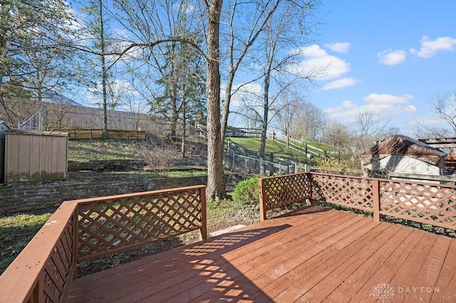 wooden terrace featuring fence