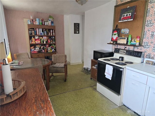 207 E Main St, New Paris, OH 45347 - kitchen with white range with electric cooktop, wallpapered walls, black microwave, white cabinetry, and light floors