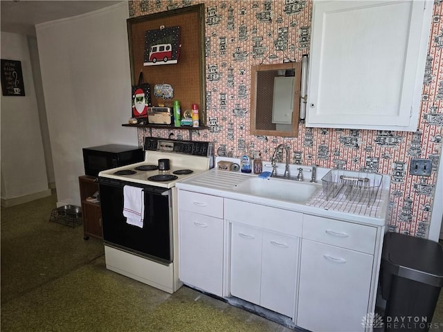 207 E Main St, New Paris, OH 45347 - kitchen featuring white electric stove, light countertops, white cabinets, black microwave, and wallpapered walls