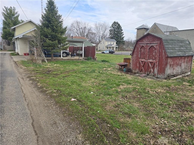 207 E Main St, New Paris, OH 45347 - view of green lawn with a storage shed
