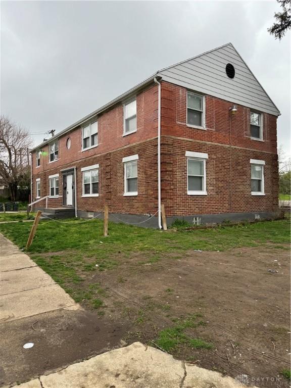 exterior space featuring brick siding