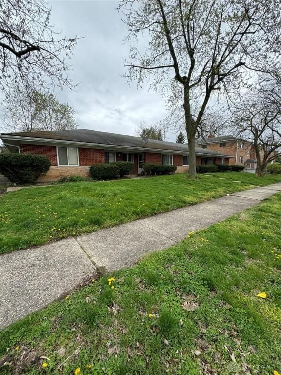 325 Ryburn Ave Unit 319-325, Dayton, OH 45405 - ranch-style house with brick siding and a front lawn