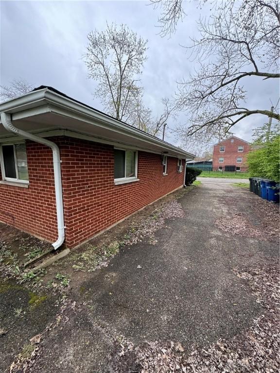 325 Ryburn Ave Unit 319-325, Dayton, OH 45405 - view of home's exterior featuring driveway and brick siding