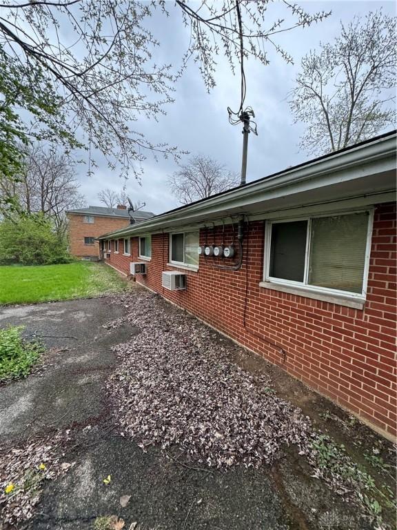 325 Ryburn Ave Unit 319-325, Dayton, OH 45405 - view of side of home featuring brick siding and a lawn