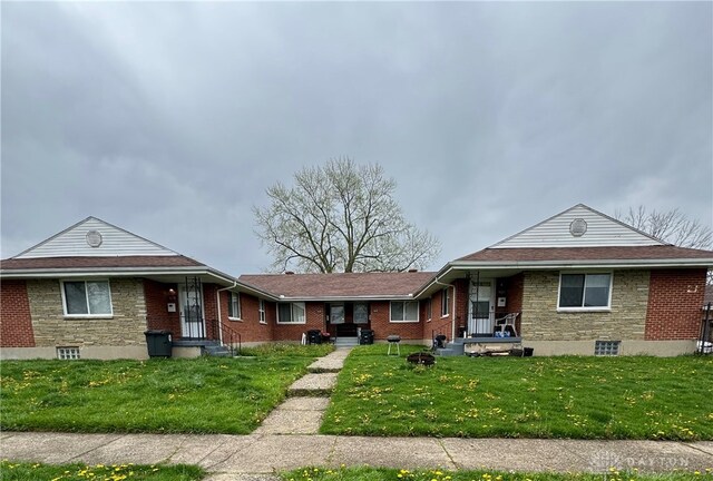 ranch-style house with brick siding and a front lawn