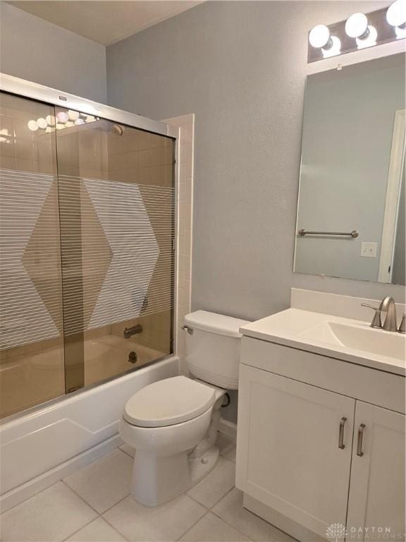 full bathroom featuring enclosed tub / shower combo, toilet, tile patterned flooring, and vanity