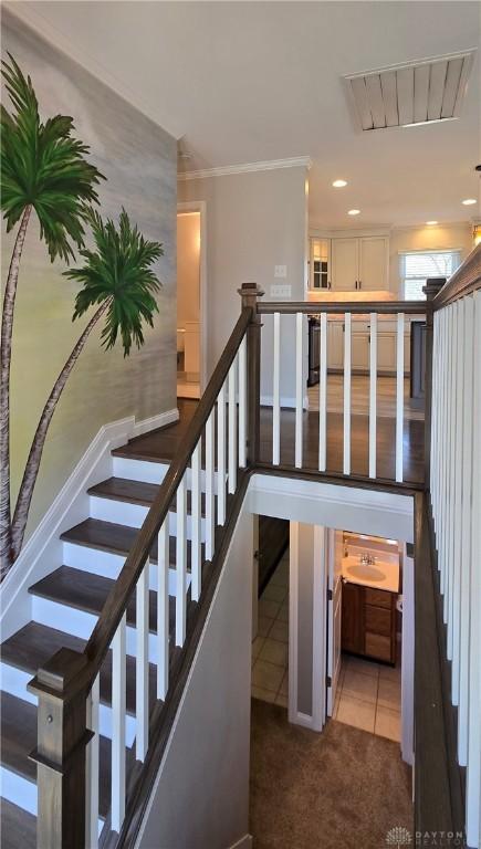stairs featuring carpet floors, tile patterned floors, recessed lighting, and crown molding