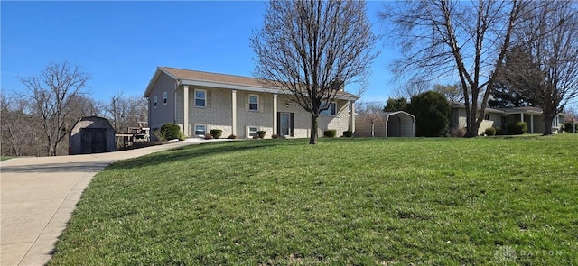 view of front of home with brick siding, a storage unit, a front lawn, a detached carport, and an outdoor structure