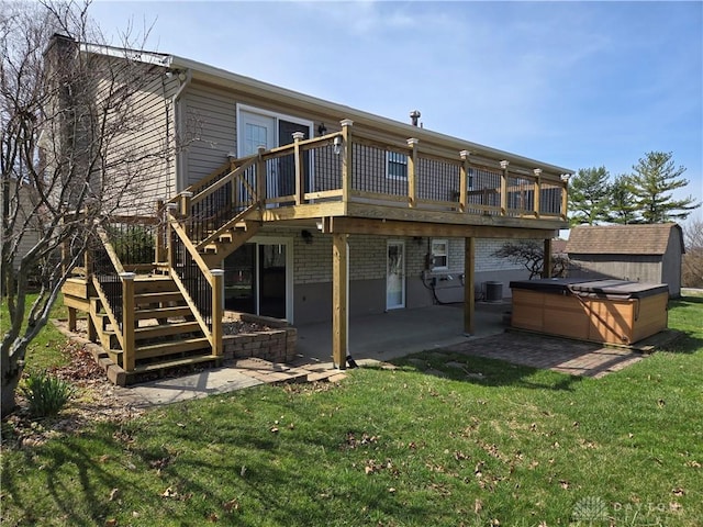 rear view of house with stairs, a patio area, a wooden deck, a hot tub, and a yard