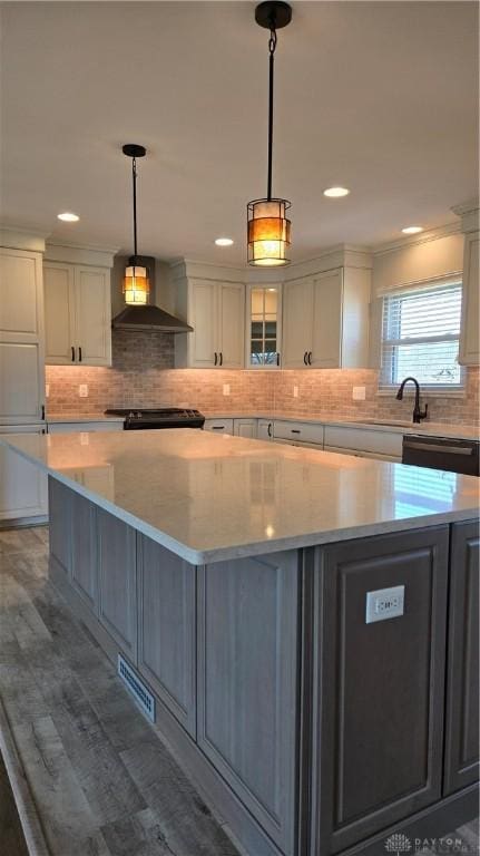 kitchen with white cabinets, glass insert cabinets, black appliances, a large island, and wall chimney range hood