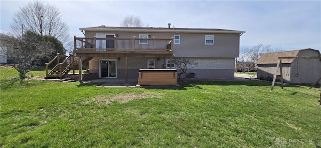back of house with an outbuilding, a hot tub, a wooden deck, stairs, and a lawn