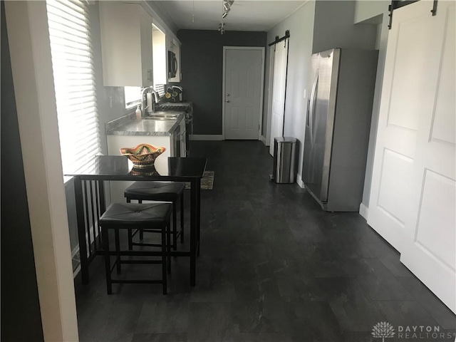 7581 Lockwood St, Dayton, OH 45415 - hall with a barn door and baseboards