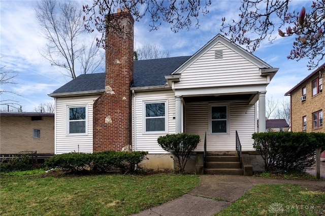 1711 Emerson Ave, Dayton, OH 45406 - view of front of property featuring a chimney, a shingled roof, a porch, and a front yard