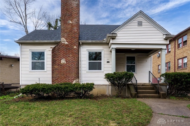 1711 Emerson Ave, Dayton, OH 45406 - view of front of property featuring a chimney, a front lawn, and roof with shingles