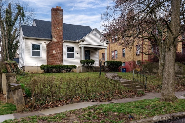 1711 Emerson Ave, Dayton, OH 45406 - view of front of house featuring a chimney and a shingled roof