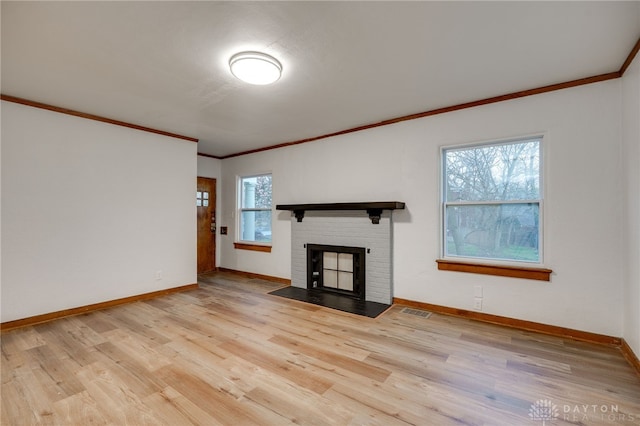 1711 Emerson Ave, Dayton, OH 45406 - unfurnished living room with visible vents, crown molding, wood finished floors, and a fireplace