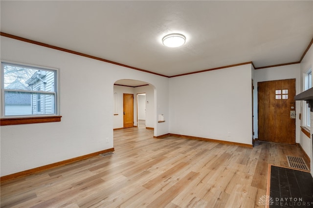 1711 Emerson Ave, Dayton, OH 45406 - spare room with visible vents, light wood finished floors, baseboards, ornamental molding, and arched walkways