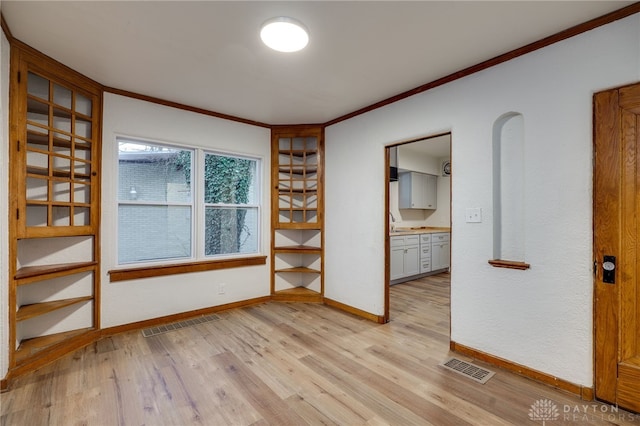 1711 Emerson Ave, Dayton, OH 45406 - unfurnished room featuring baseboards, crown molding, visible vents, and light wood-type flooring