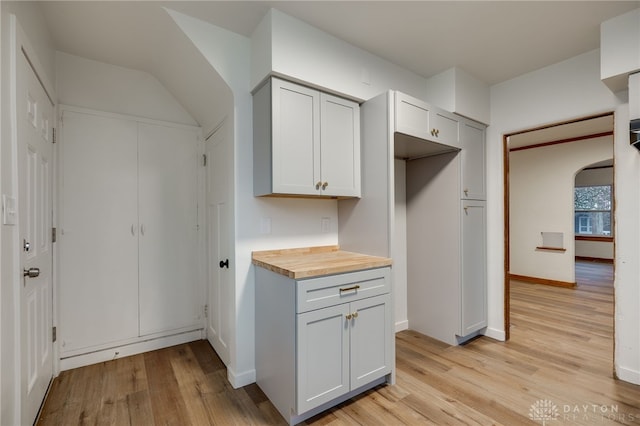 1711 Emerson Ave, Dayton, OH 45406 - kitchen with light wood-style flooring, baseboards, arched walkways, and butcher block countertops