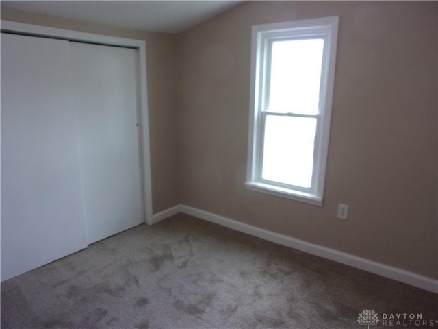 127 New Burlington Rd, Waynesville, OH 45068 - unfurnished bedroom with a closet, baseboards, and light carpet