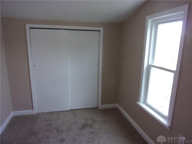 127 New Burlington Rd, Waynesville, OH 45068 - unfurnished bedroom featuring baseboards, lofted ceiling, a closet, and carpet flooring