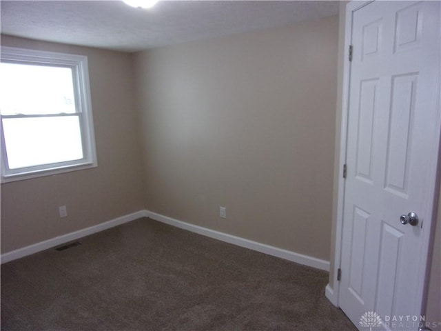 127 New Burlington Rd, Waynesville, OH 45068 - unfurnished room with baseboards, visible vents, and dark colored carpet