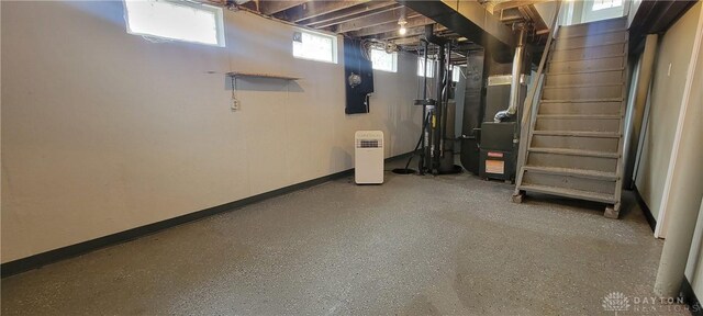 basement featuring heating unit and baseboards