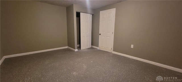 spare room featuring baseboards