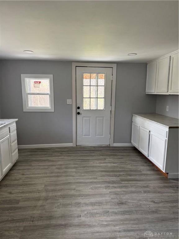6718 Faversham Rd, Miamisburg, OH 45342 - interior space with baseboards, white cabinetry, light countertops, and dark wood finished floors